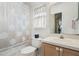 Bright bathroom with a seashell-themed shower curtain and a white vanity at 827 Challenger Ave, Davenport, FL 33897