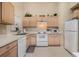 Functional kitchen features white appliances, tile flooring, and ample cabinet space at 827 Challenger Ave, Davenport, FL 33897