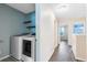 Hallway featuring a laundry room, bedroom, and neutral paint at 8670 Vedder Ln, Orlando, FL 32832