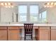 Double vanity bathroom with light wood cabinets and a bright and airy feel at 897 Landrum Dr, Winter Garden, FL 34787