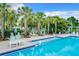 Relaxing pool area with plenty of lounge chairs and palm trees at 897 Landrum Dr, Winter Garden, FL 34787