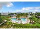 Community pool with lounge chairs and umbrellas at 897 Landrum Dr, Winter Garden, FL 34787