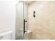 Beige tile shower with glass enclosure and bench at 906 Reserve Pl, Davenport, FL 33896