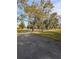 Asphalt driveway meandering through a tree-lined landscape at 9430 Kilgore Rd, Orlando, FL 32836