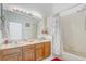 Bathroom with dual sinks, a large mirror, and a shower-tub combo at 9716 Pecky Cypress Way, Orlando, FL 32836