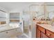 Well-lit bathroom featuring a tub and glass-enclosed shower at 9716 Pecky Cypress Way, Orlando, FL 32836