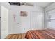 Bedroom featuring wood laminate floors and a white closet door at 9716 Pecky Cypress Way, Orlando, FL 32836