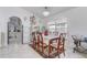 Bright dining area featuring a chandelier, shelving, and backyard views at 9716 Pecky Cypress Way, Orlando, FL 32836