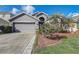 Charming single-Gathering home with a well-maintained front yard and a two-car garage at 9716 Pecky Cypress Way, Orlando, FL 32836
