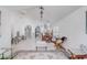 Open-concept living and dining area with white walls, tile floors, and ample natural light at 9716 Pecky Cypress Way, Orlando, FL 32836