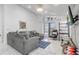 Comfortable living room with a large sectional sofa and access to the outdoor area at 9716 Pecky Cypress Way, Orlando, FL 32836