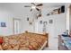 Bright main bedroom featuring white walls, tile floors, and a ceiling fan at 9716 Pecky Cypress Way, Orlando, FL 32836