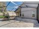 An airy, screened-in patio provides a shaded outdoor seating area with a swing and workout equipment at 9716 Pecky Cypress Way, Orlando, FL 32836