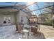 A screened-in patio features a swing and an outdoor seating area under a sunny sky at 9716 Pecky Cypress Way, Orlando, FL 32836