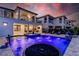 Stunning pool and spa with colorful lighting at dusk at 1039 Jack Nicklaus Ct, Kissimmee, FL 34747