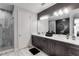 Elegant bathroom with double vanity, large mirror, and a walk-in shower at 1039 Jack Nicklaus Ct, Kissimmee, FL 34747
