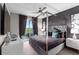 Luxury bedroom with four-poster bed and private balcony at 1039 Jack Nicklaus Ct, Kissimmee, FL 34747