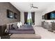 Main bedroom with large TV, balcony access, and modern decor at 1039 Jack Nicklaus Ct, Kissimmee, FL 34747