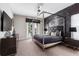 Luxurious bedroom with a king-size bed and a large TV at 1039 Jack Nicklaus Ct, Kissimmee, FL 34747