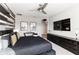Stylish bedroom with large TV and wood wall accents at 1039 Jack Nicklaus Ct, Kissimmee, FL 34747