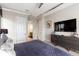 Spacious main bedroom with large TV, dresser and en-suite bathroom at 1039 Jack Nicklaus Ct, Kissimmee, FL 34747