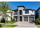 Two-story house with gray exterior, two-car garage, and stone accents at 1039 Jack Nicklaus Ct, Kissimmee, FL 34747