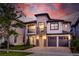 Two-story house with gray exterior, two-car garage, and stone accents at 1039 Jack Nicklaus Ct, Kissimmee, FL 34747