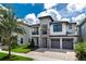 Modern two-story house with gray garage doors and stone accents at 1039 Jack Nicklaus Ct, Kissimmee, FL 34747