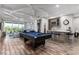 Game room with pool table, wet bar, and comfortable seating at 1039 Jack Nicklaus Ct, Kissimmee, FL 34747