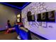 Game room features arcade game and large screen TV at 1039 Jack Nicklaus Ct, Kissimmee, FL 34747
