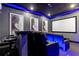 Home theater with black recliner seats, a large screen, and ocean-themed wall art at 1039 Jack Nicklaus Ct, Kissimmee, FL 34747