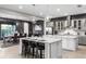 Spacious kitchen with gray cabinets, white island, and stainless steel appliances at 1039 Jack Nicklaus Ct, Kissimmee, FL 34747