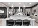Spacious kitchen with gray cabinets, white island, and stainless steel appliances at 1039 Jack Nicklaus Ct, Kissimmee, FL 34747