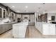 Spacious kitchen with gray cabinets, white island, and stainless steel appliances at 1039 Jack Nicklaus Ct, Kissimmee, FL 34747