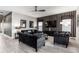 Living area features dark sofas, a neutral rug, and large windows with blinds at 1039 Jack Nicklaus Ct, Kissimmee, FL 34747