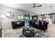 Open concept living room with kitchen access, plush sofas, and a stylish coffee table at 1039 Jack Nicklaus Ct, Kissimmee, FL 34747