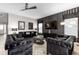 Spacious living room boasts a black and grey color scheme, stylish furniture, and large TV at 1039 Jack Nicklaus Ct, Kissimmee, FL 34747