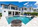 Luxury pool with fire pit and spa, surrounded by lounge chairs and modern landscaping at 1039 Jack Nicklaus Ct, Kissimmee, FL 34747
