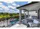 Covered balcony with patio furniture overlooking the pool and green space at 1039 Jack Nicklaus Ct, Kissimmee, FL 34747