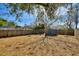 Large backyard with mature trees and wood fence at 105 N Ortman Dr, Orlando, FL 32805