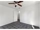 An open and airy bedroom features tile floors, a ceiling fan, neutral paint and an ensuite bathroom at 105 N Ortman Dr, Orlando, FL 32805