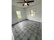 Inviting bedroom with natural light, neutral decor, and ceiling fan for added comfort and tiled flooring at 105 N Ortman Dr, Orlando, FL 32805