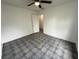 Clean and simple bedroom design with tiled floors, a ceiling fan, and a door leading to another room at 105 N Ortman Dr, Orlando, FL 32805