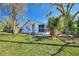 Cozy single-story home featuring a screened-in porch, fenced yard, and mature trees at 105 N Ortman Dr, Orlando, FL 32805