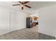 Open-concept area with tile floor and kitchen view featuring black appliances and wood cabinets at 105 N Ortman Dr, Orlando, FL 32805