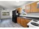 Charming kitchen featuring wooden cabinets, black appliances, and tile floors at 105 N Ortman Dr, Orlando, FL 32805