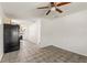 Open living space featuring tile flooring, a ceiling fan and access to other rooms at 105 N Ortman Dr, Orlando, FL 32805