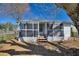 Charming screened-in porch with wood steps, offering a relaxing outdoor space at 105 N Ortman Dr, Orlando, FL 32805
