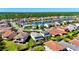 Aerial view of the community, featuring a lake, streets, manicured lawns, and mature trees at 10680 Royal Cypress Way, Orlando, FL 32836