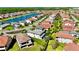 Aerial view of the community featuring a serene lake, streets, and lush green lawns at 10680 Royal Cypress Way, Orlando, FL 32836